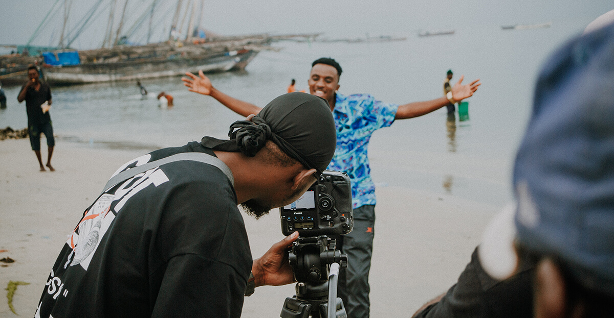 RftD-Tanzania-Musicalizing-centre-behindthescenes2 Two men filming on beach