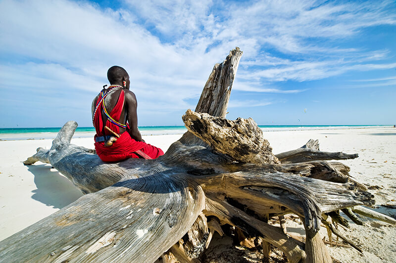 about-grid-1 Maasai sitting by the ocean on the beach